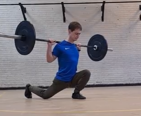 An athlete doing Knees over toes split squat for strength and mobility