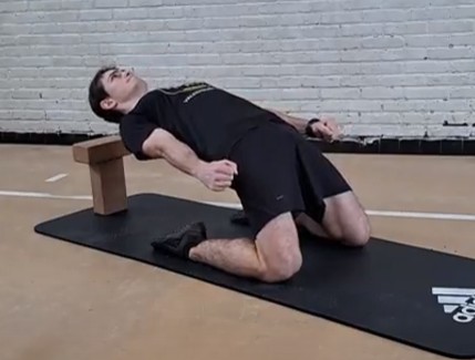 An athlete doing a reverse nordic curl