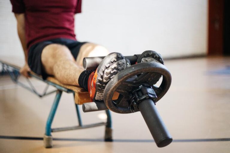 an athlete using the tib bar on the bench