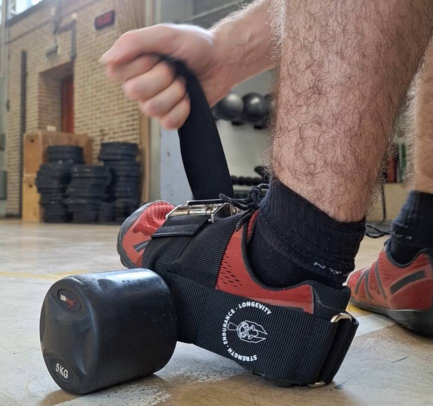the process of strapping the ankle strap for dumbbells