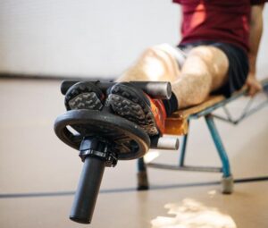 athlete in the middle of a tib bar exercise for tib bar benefits