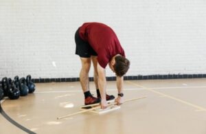 An athlete doing slant board calf stretches to improve ankle dorsiflexion