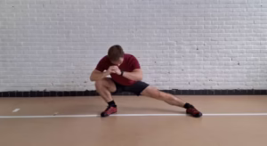 an athlete doing a side lunge dynamic stretch