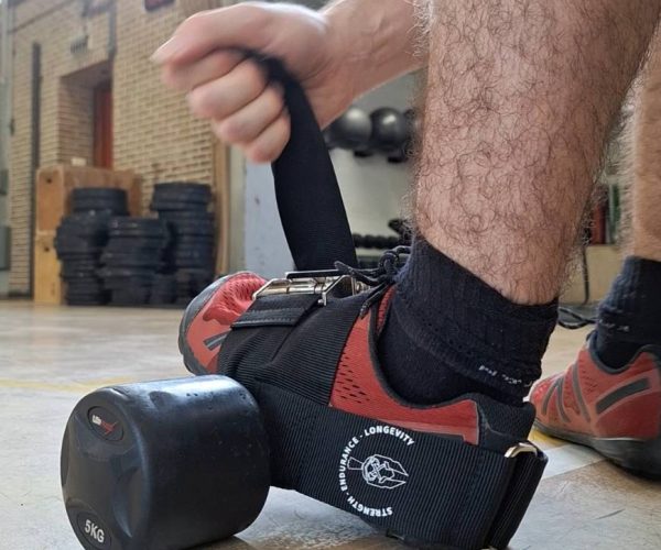 the process of strapping the ankle strap for dumbbells