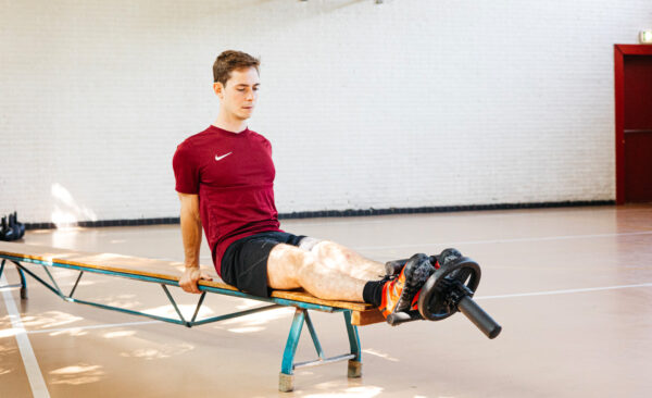 an athlete working out with his tib bar
